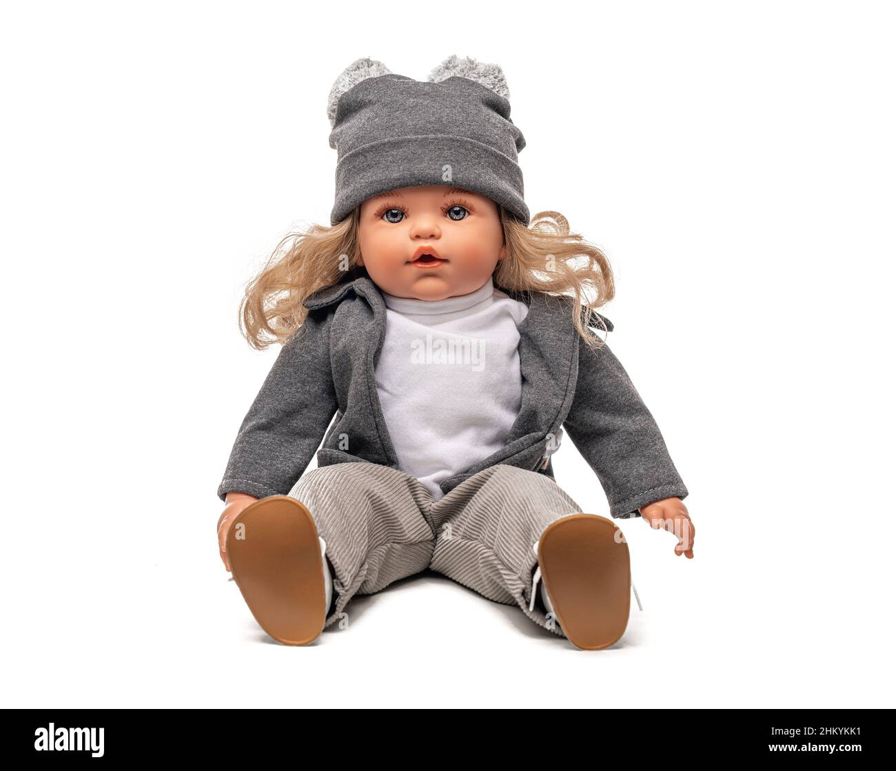 Little plastic doll baby girl isolated on white. Stock Photo