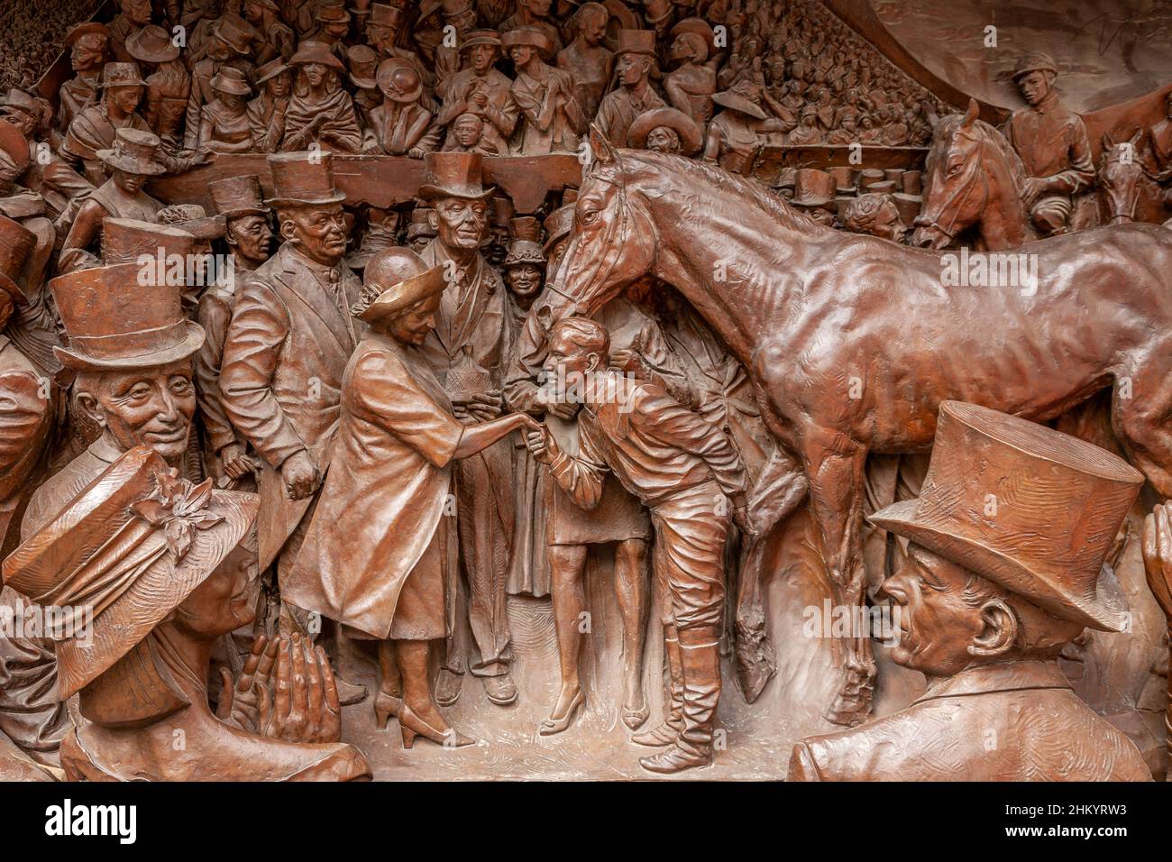 Bronze relief panel flanking the statue of Queen Elizabeth The Queen Mother, The Mall, London, UK Stock Photo