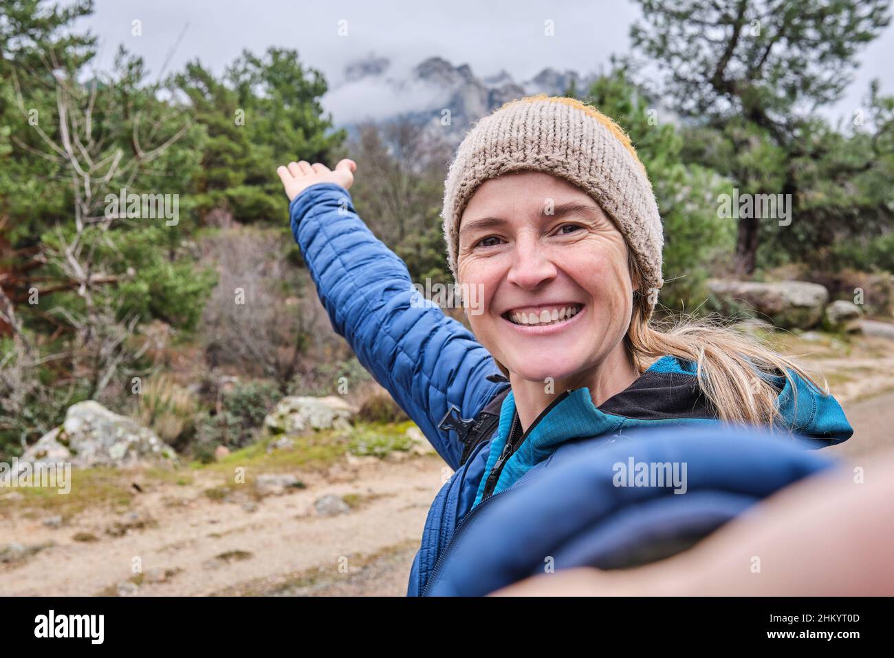 A happy beautiful woman taking a selfie portrait with smartphone on ...