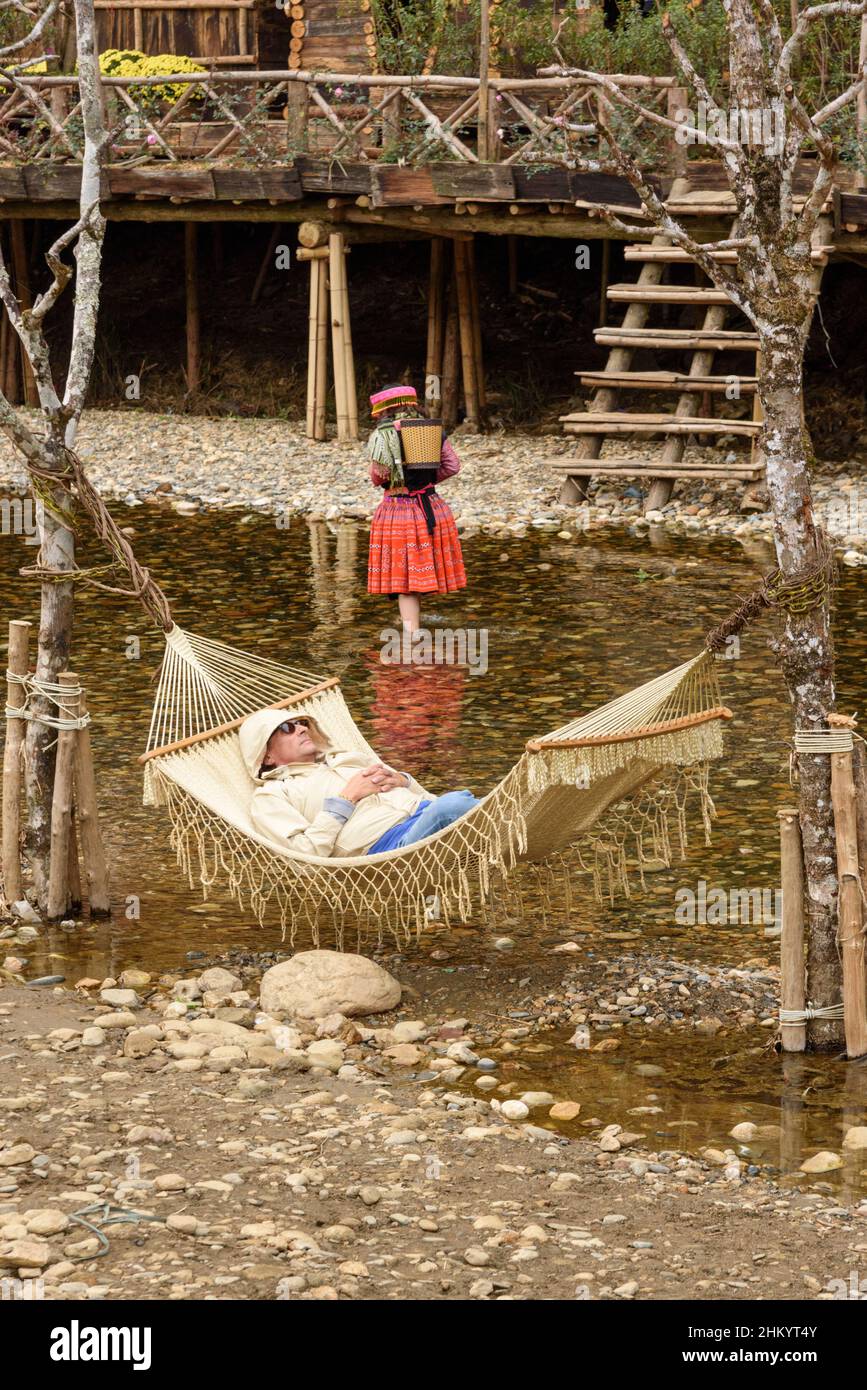 Two tourists relax in Cat Cat village, Sapa (Sa Pa), Lao Cai Province, Vietnam, Southeast Asia Stock Photo