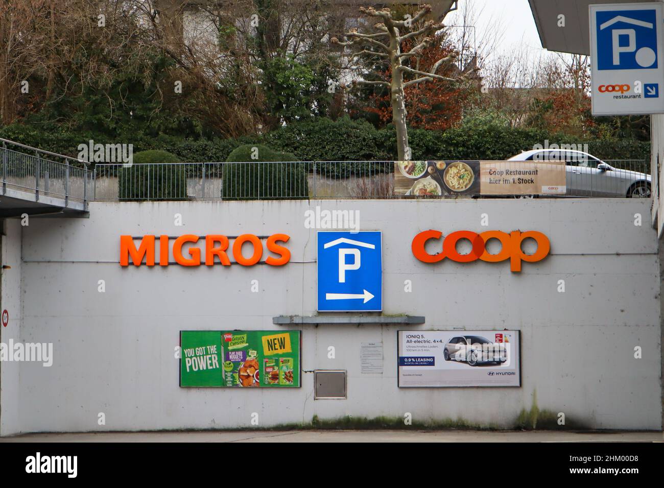 Herzogenbuchsee, Switzerland, 03. January 2022: Entry to the Parking of the two biggest Companys Coop and Migros. Stock Photo
