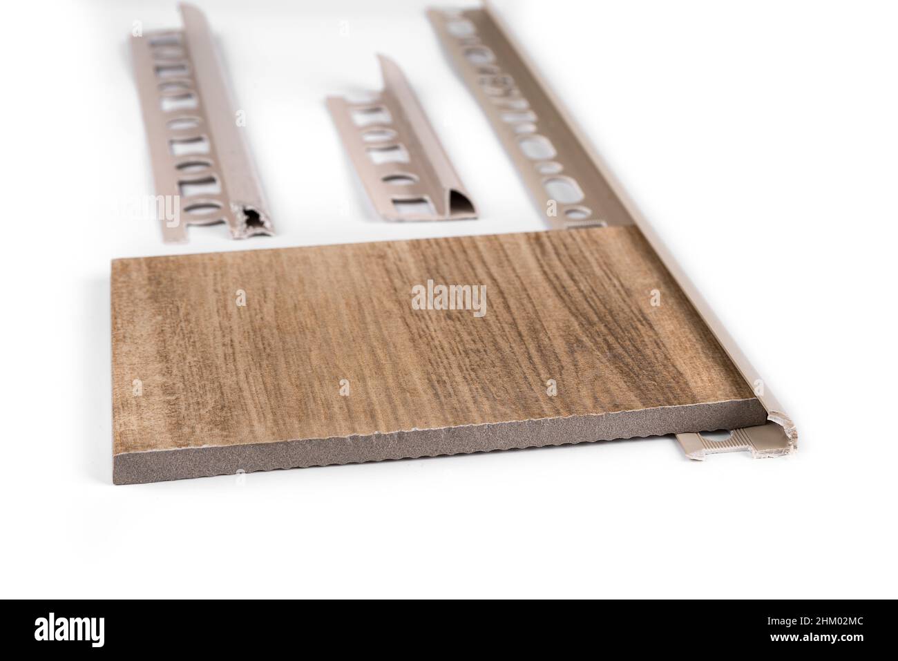 Round edge plastic ceramic tile trim on a white background Stock Photo