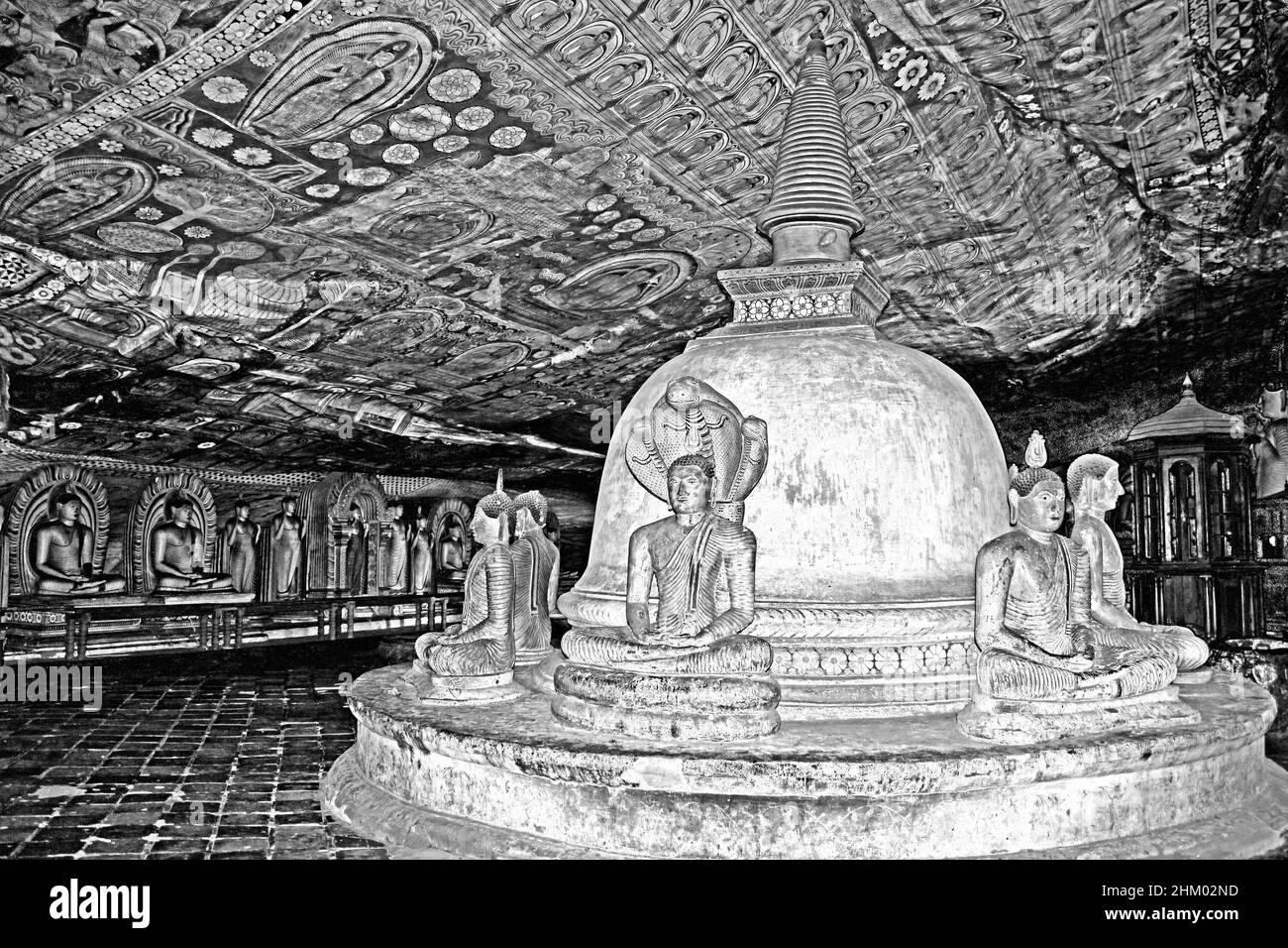Muchalinda Cobra Hood protecting the Lord Buddha images seated around stupa at Maharajalena Cave Temple, Dambulla Stock Photo