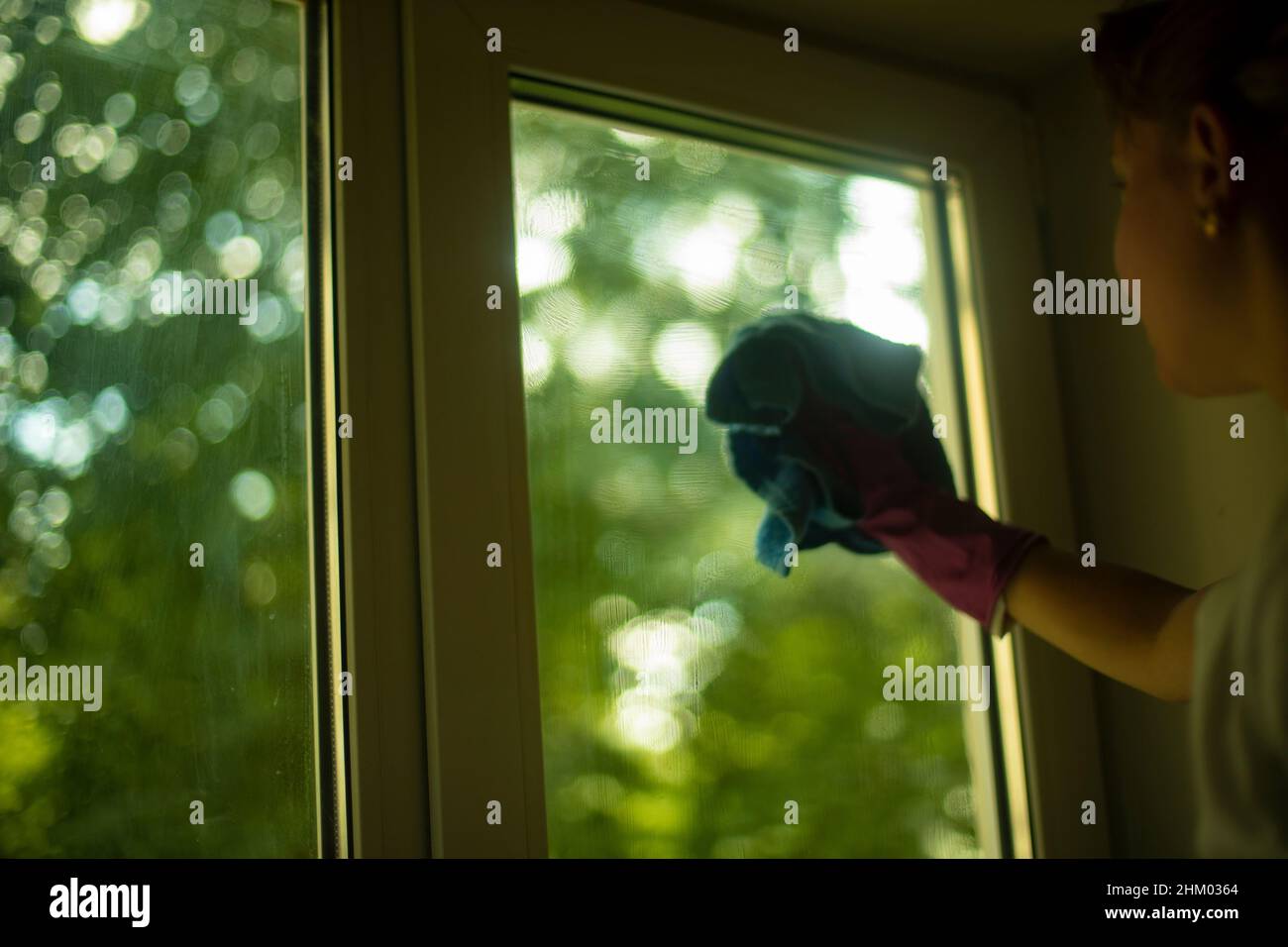 Washes the window with a rag. Cleaning windows from dirt. House ...