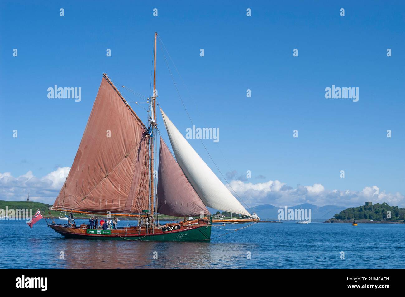 Gaff-cutter sailing on a lovely day in July in Oban Harbour, Inner Hebrides, Scotland, UK Stock Photo