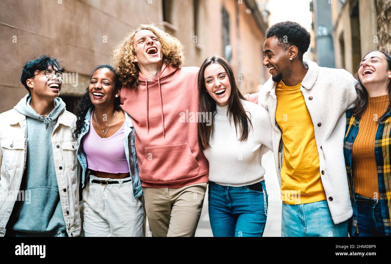 Life style concept with milenial friends walking together at old town center - Happy guys and girls having fun around Barcelona streets - University s Stock Photo