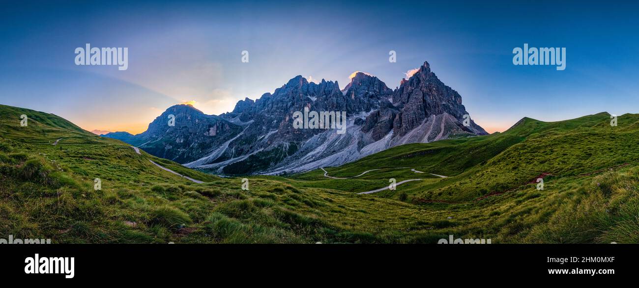 Panoramic view of summits and rock faces of the Pala group, rising over the valley Val Venegia, seen from above Rolle Pass at sunrise. Stock Photo