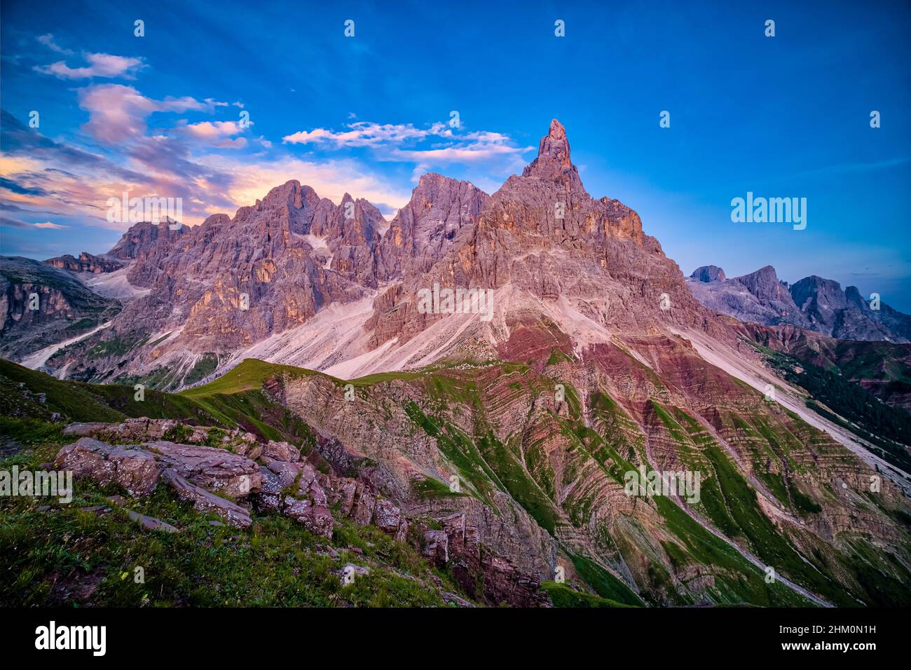 Summits and rock faces of the Pala group, Cimon della Pala, one of the main summits, standing out, seen from above Rolle Pass at sunset. Stock Photo