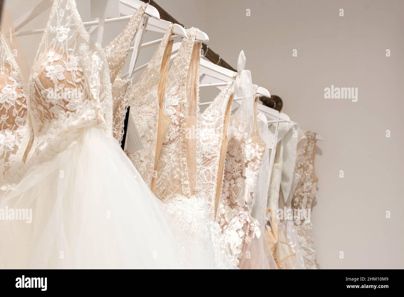 Brunette Bride Lace Bra Holding White Wedding Dress Hanger Home Stock Photo  by ©HayDmitriy 397969284
