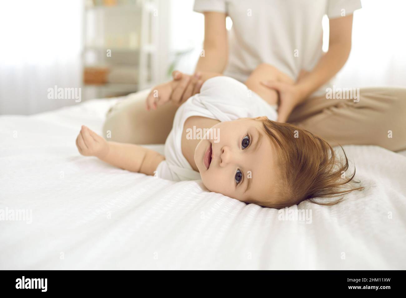 Close up portrait of cute and adorable six month old baby girl lying on