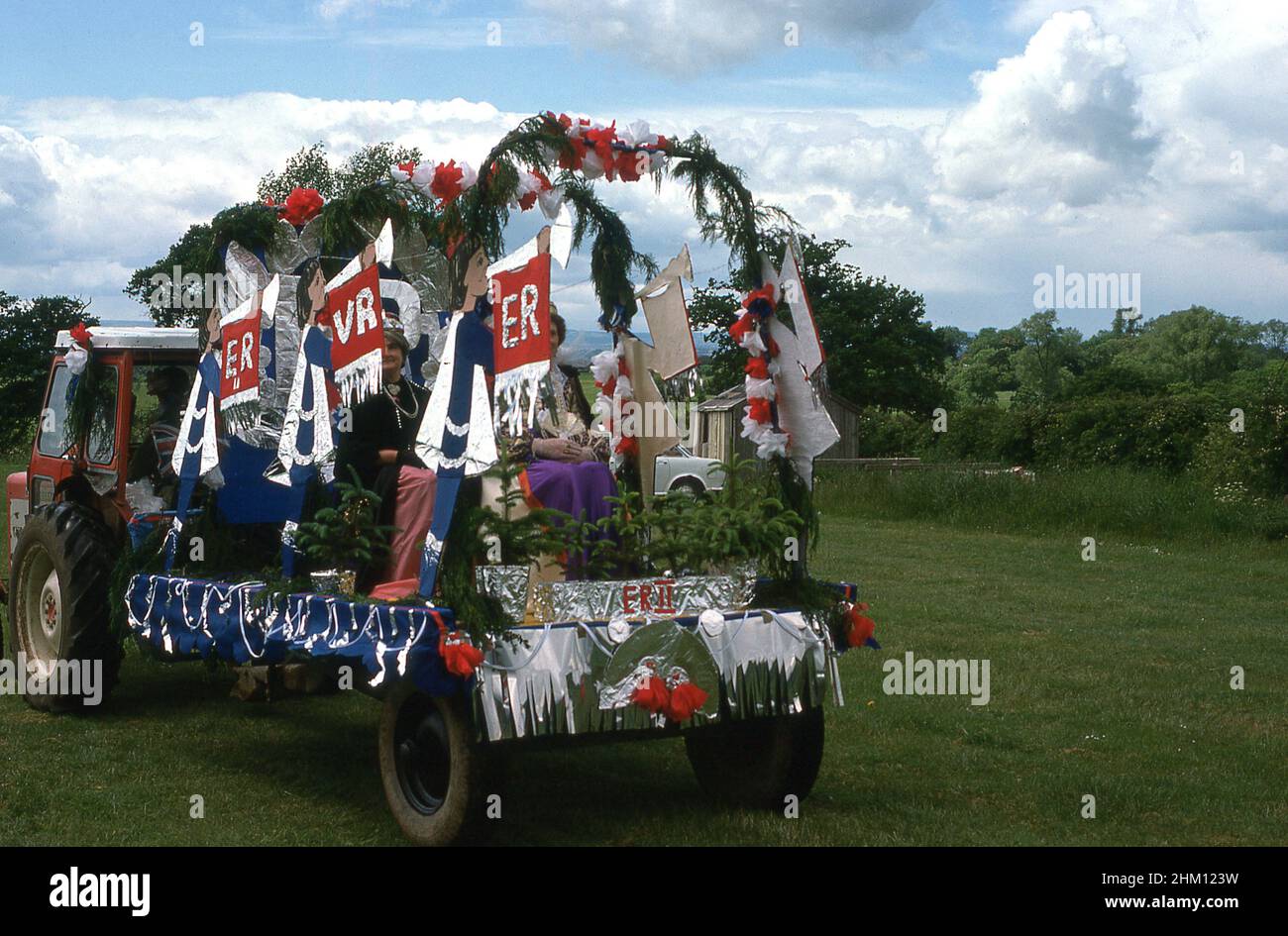 1977, historical, on the back of a tractor, a decorated parade float celebrating the Queen Elizabeth II silver jubilee, England, UK. Stock Photo
