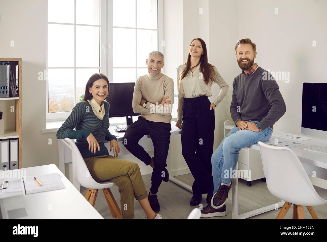 Group portrait of happy, smiling corporate employees in a modern office workplace Stock Photo
