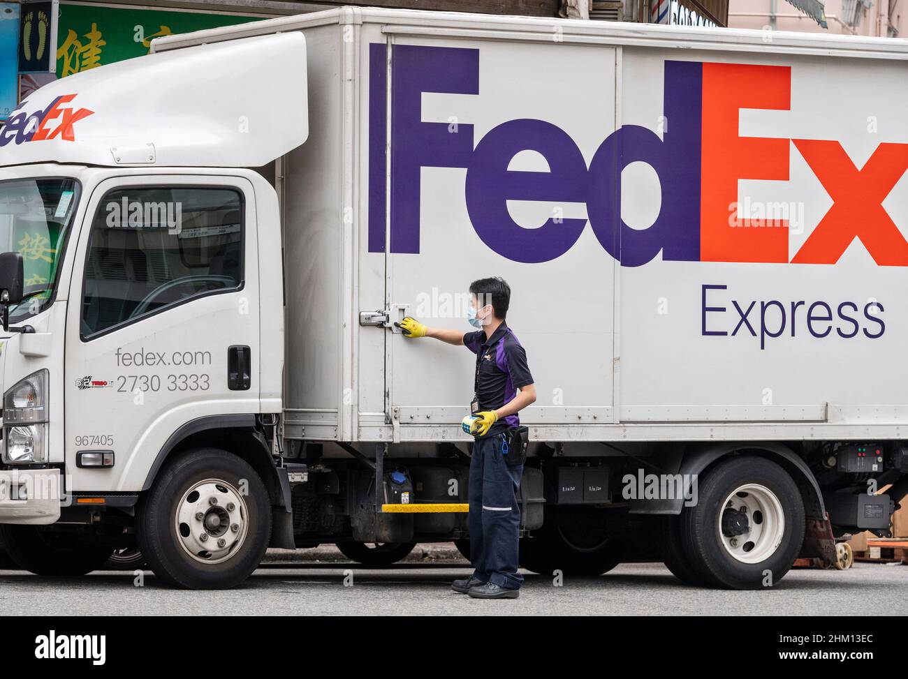 An American FedEx Express company courier closes his