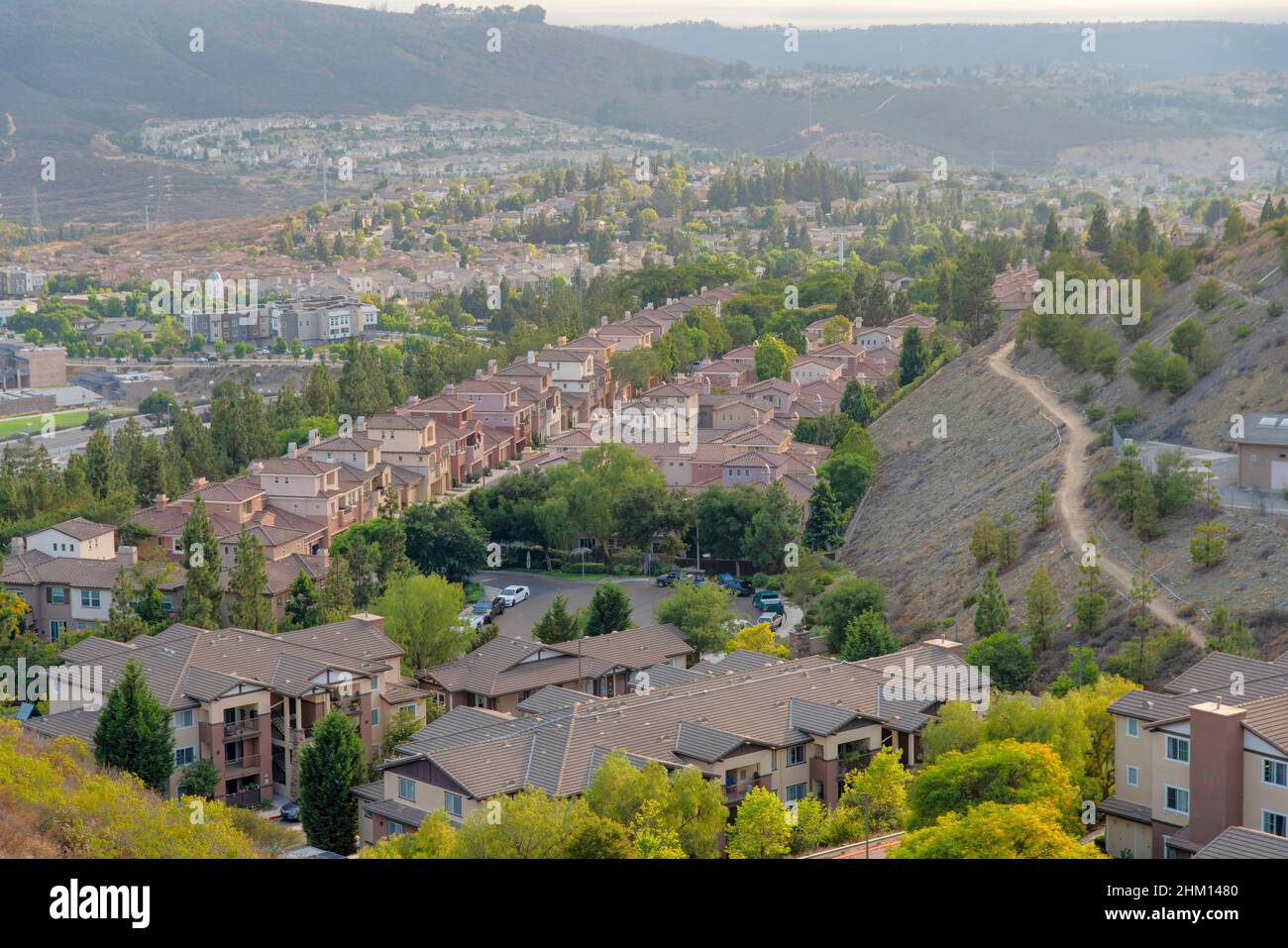 Row of houses in a residential area with Cul-de-Sac near Double Peak Park, San Marcos, California. Mountainside residences with trail in the middle of Stock Photo