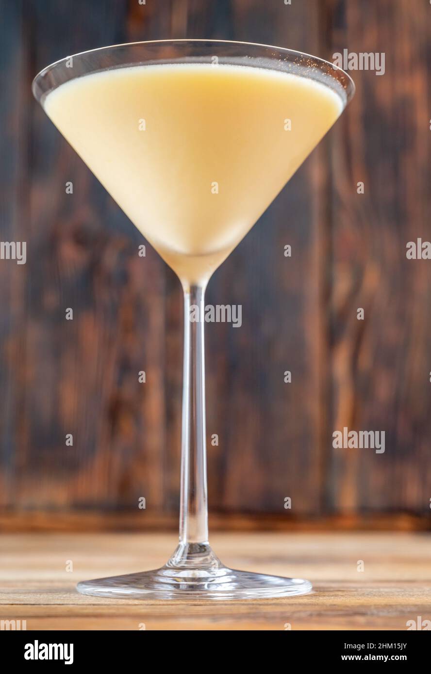 Glass of Canary Flip Cocktail garnished with lemon zest twist Stock Photo