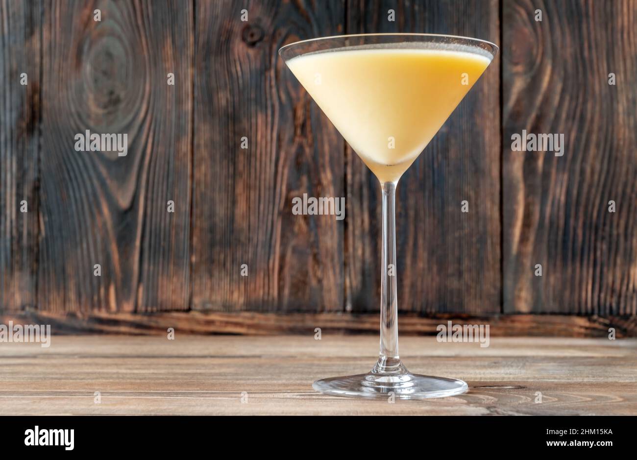 Glass of Canary Flip Cocktail garnished with lemon zest twist Stock Photo