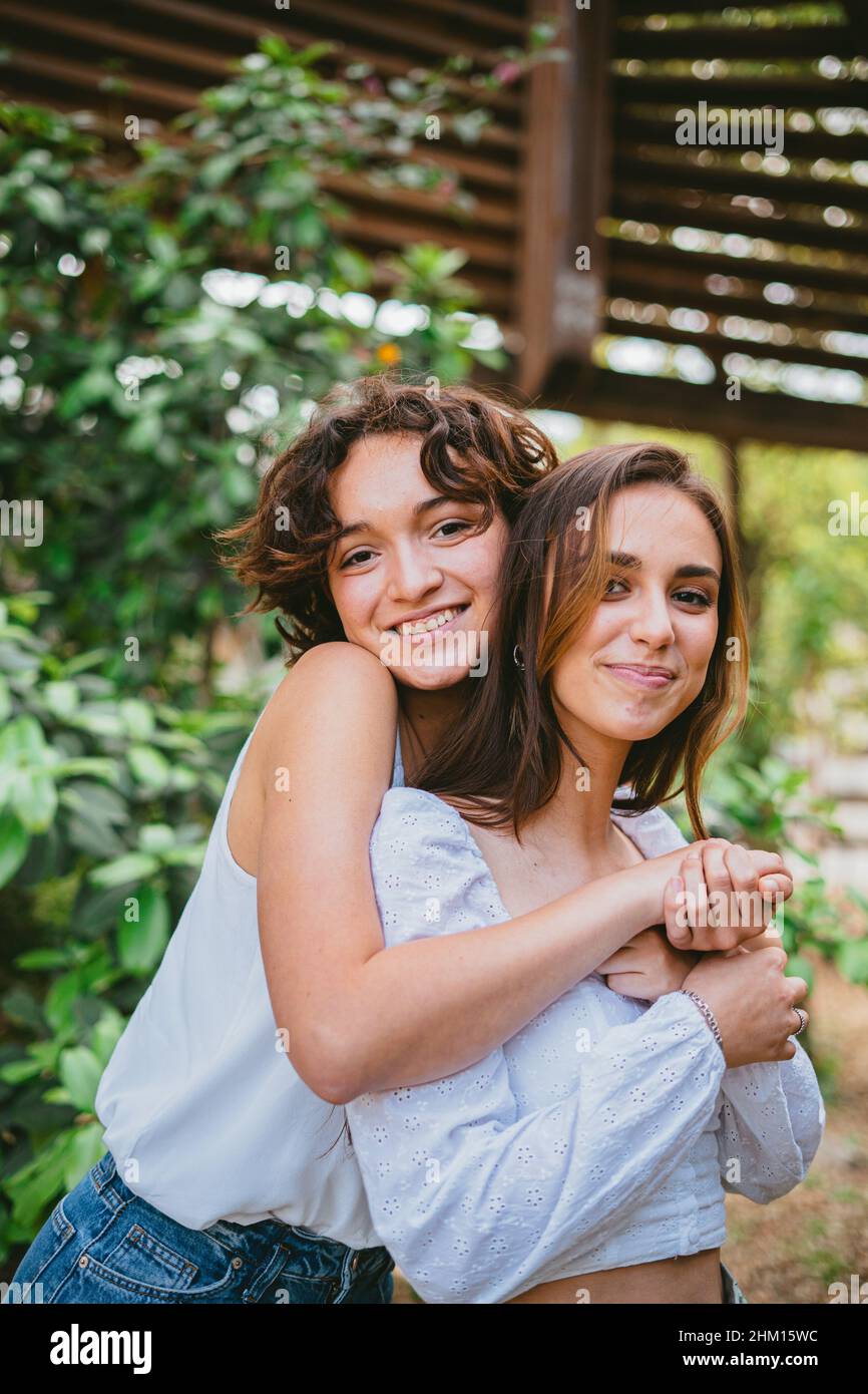 Two friends hugging teenager hi-res stock photography and images - Alamy