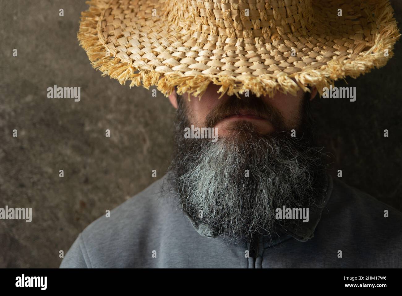 A napping man with a long beard in a hat, male portrait Stock Photo