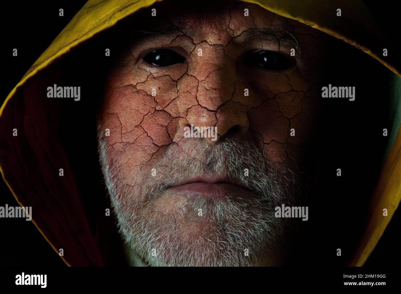 Demons among us. A man's face into which a creature has entered. Stock Photo
