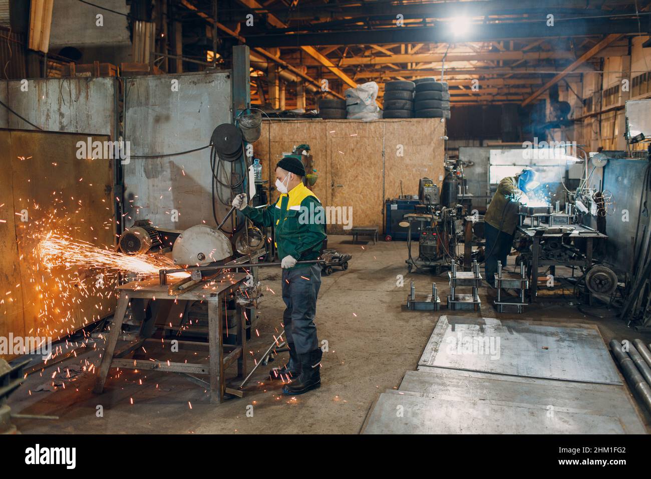 Workers working with metal construction on plant. Metal processing with