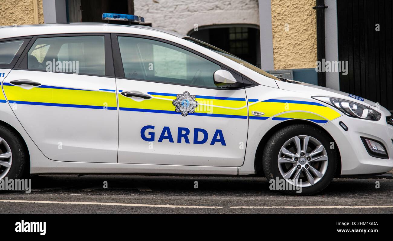 Garda, description on police car, with yellow and blue stripes on sides Stock Photo