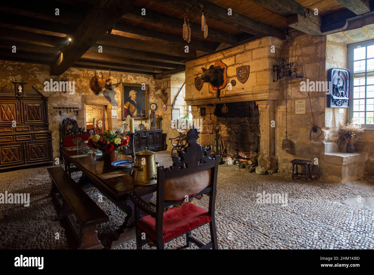 Tursac, France - November 5, 2021: Renaissance interior of the Maison forte de Reignac de  with antic furniture, fireplace, but with no people Stock Photo