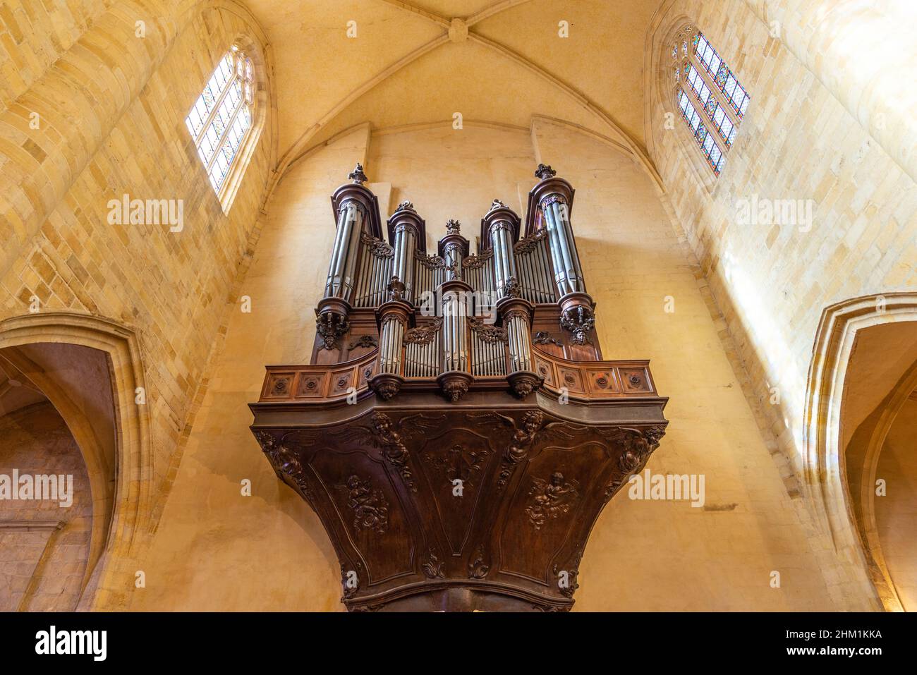 An old organ in a beautiful french yellow stone medieval church in Sarlat-la-Caneda, Perigord, France, taken on a sunny autumn afternoon Stock Photo