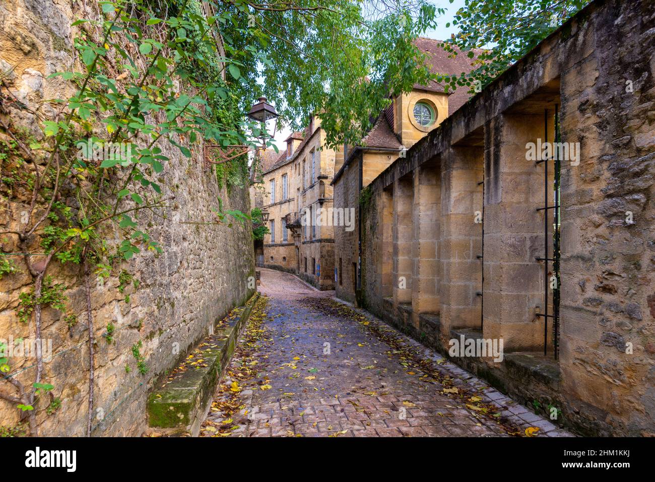 The narrow street of a beautiful french yellow stone medieval town of Sarlat-la-Caneda located in Perigord, France, taken on a sunny autumn afternoon Stock Photo