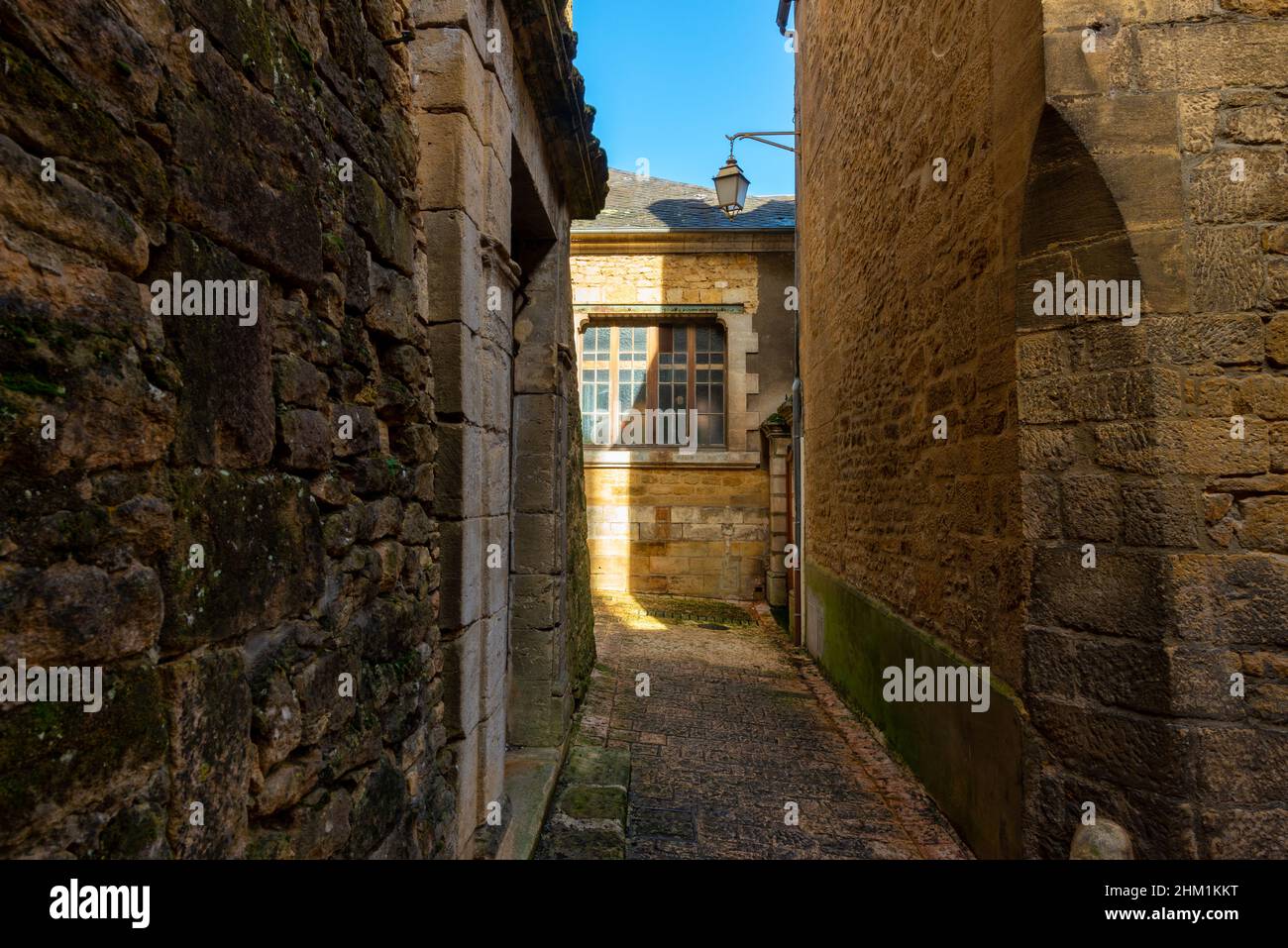 The narrow street of a beautiful french yellow stone medieval town of Sarlat-la-Caneda located in Perigord, France, taken on a sunny autumn afternoon Stock Photo
