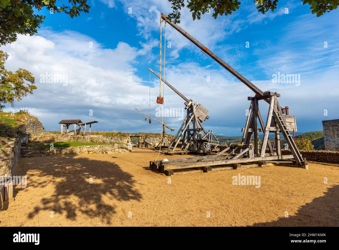 Two medieval war catapults located in the Castelnaud fortress. Taken in Perigord, France, on a sunny autumn afternoon Stock Photo