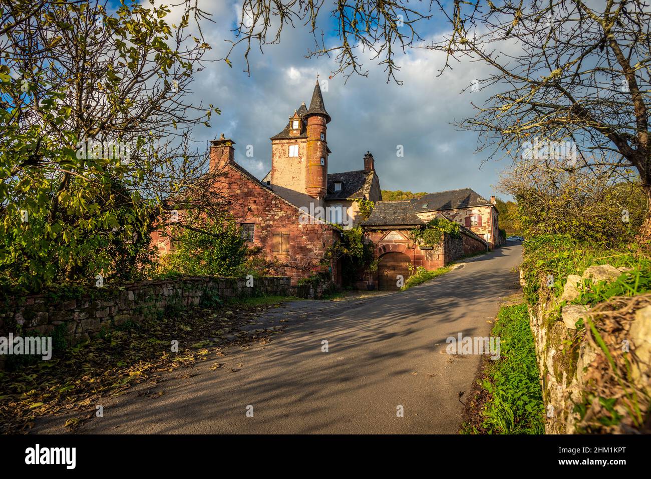 A picturesque and intricate red stone manor in Collonges-la-Rouge,  Correze, France, taken on a partly sunny autumn afternoon with no people. Stock Photo