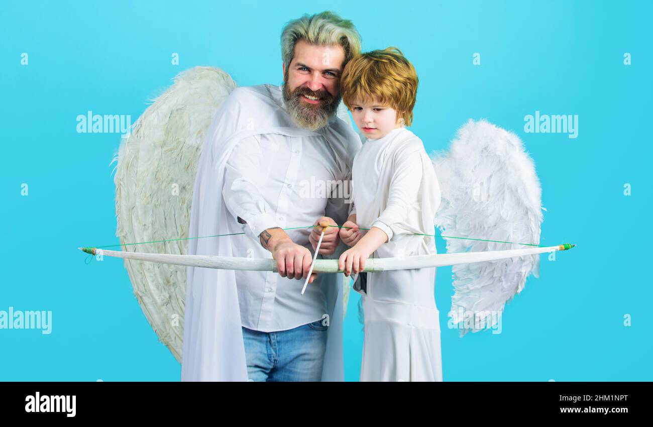 Valentines Day. Father and son angels with bow and arrow. Valentine cupid with white wings. Stock Photo