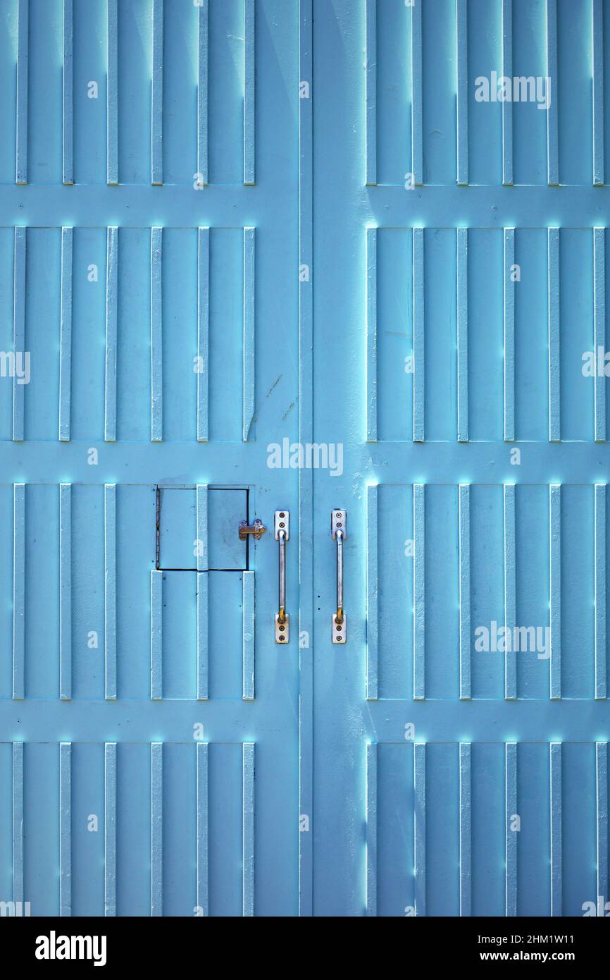 Wooden garage door with bright turquoise as a background material Stock Photo