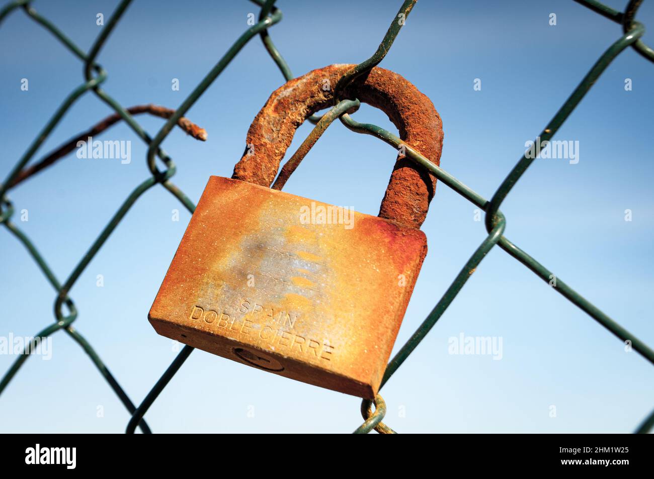 Rusty padlock on an old fence Stock Photo