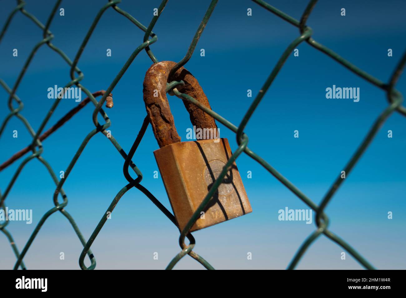 Rusty padlock on an old fence Stock Photo