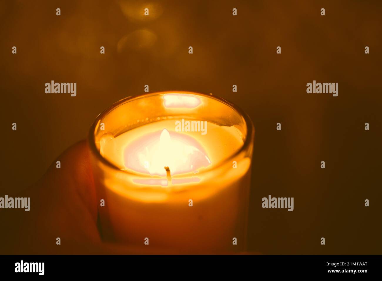 Closeup of a hand cupping a lit candle Stock Photo Alamy