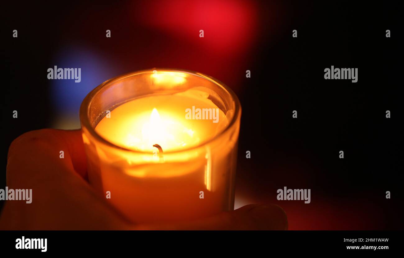 Closeup of a hand cupping a lit candle Stock Photo Alamy