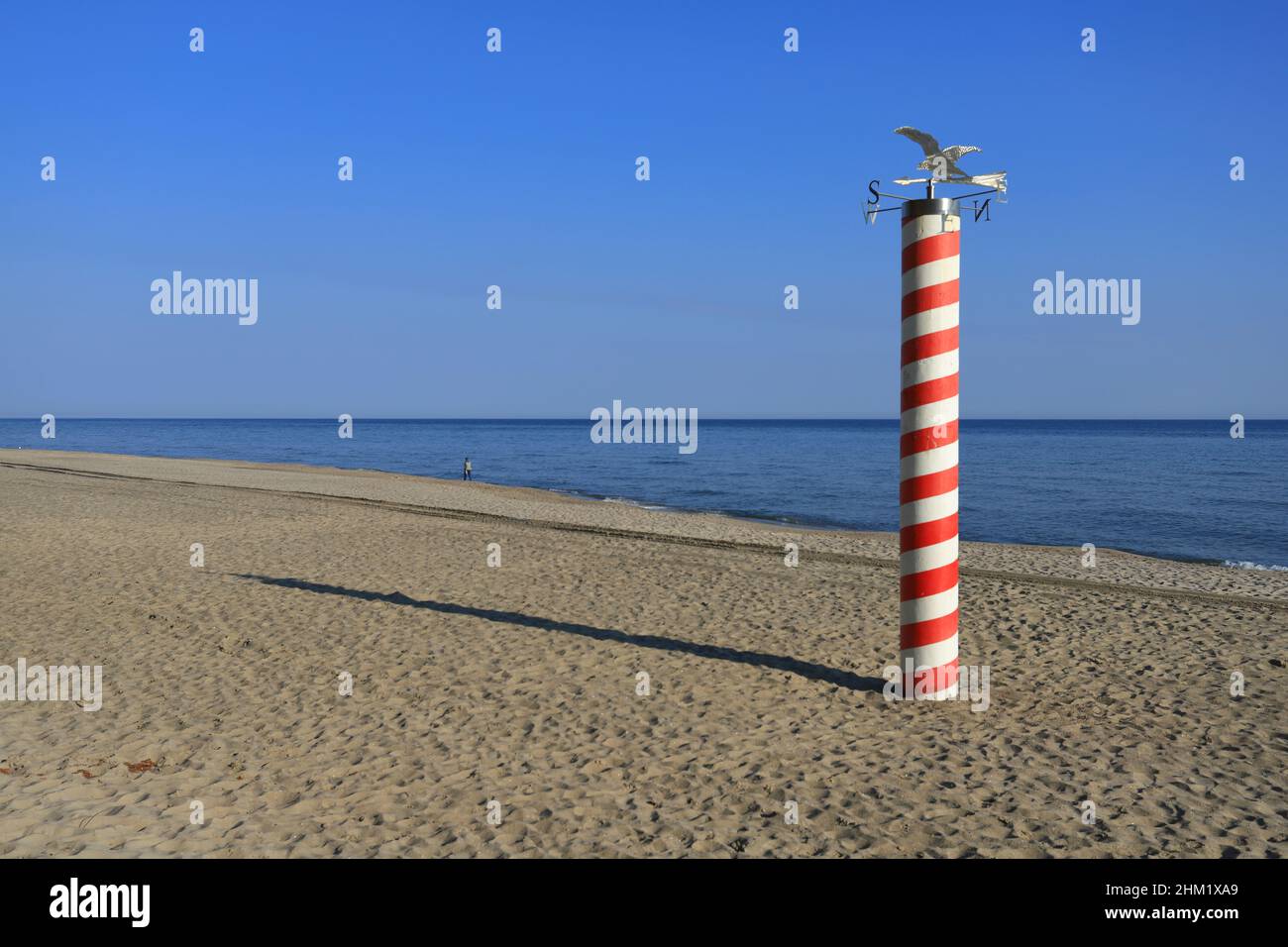 Red and white pillar as symbol of the most northern point of Poland. Pole at Jastrzebie Gora beach. Stock Photo