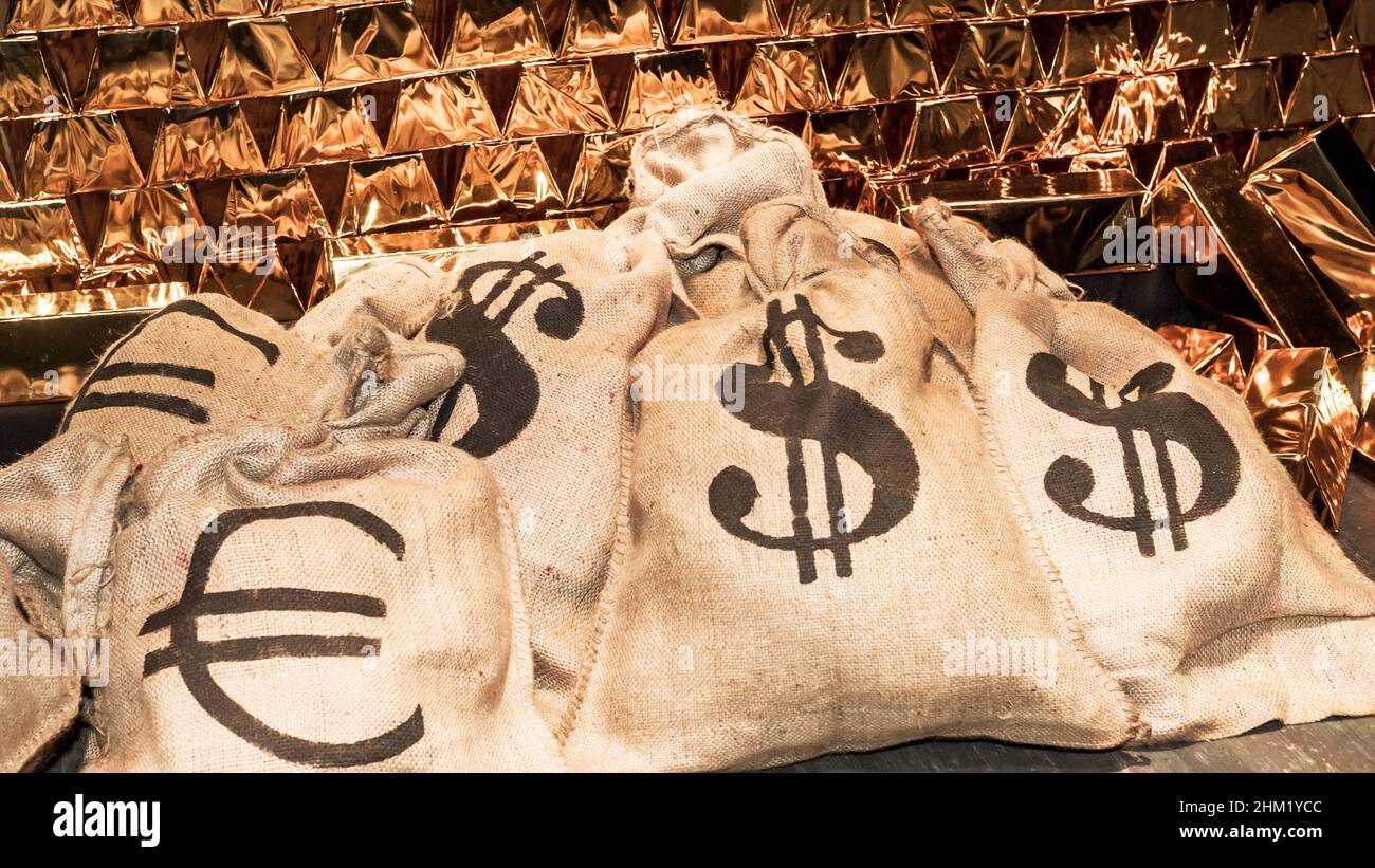theatrical scenery, money bags with US dollar, Euro and gold bullion Stock Photo