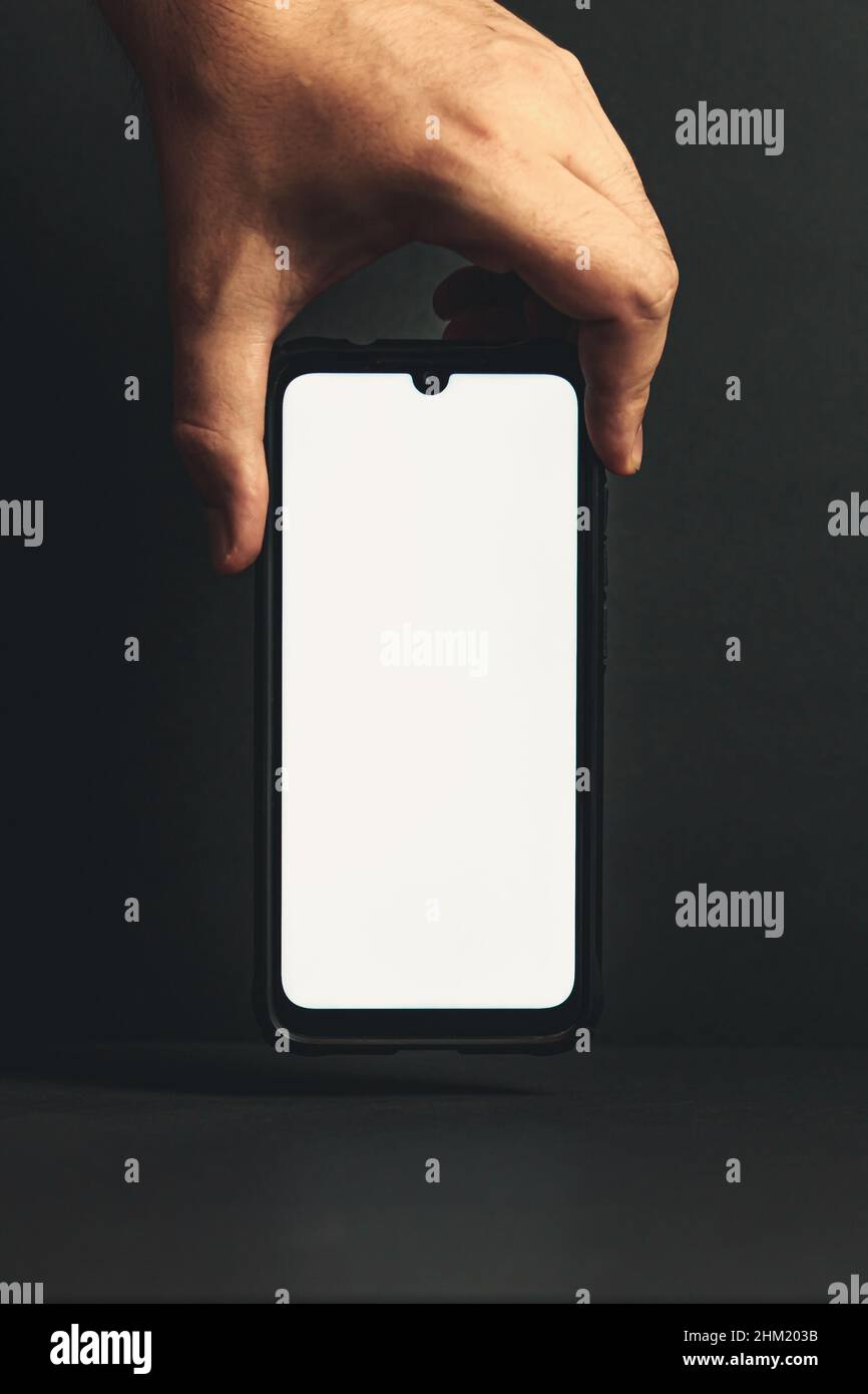 Hand grabbing a phone with copy space Stock Photo Alamy