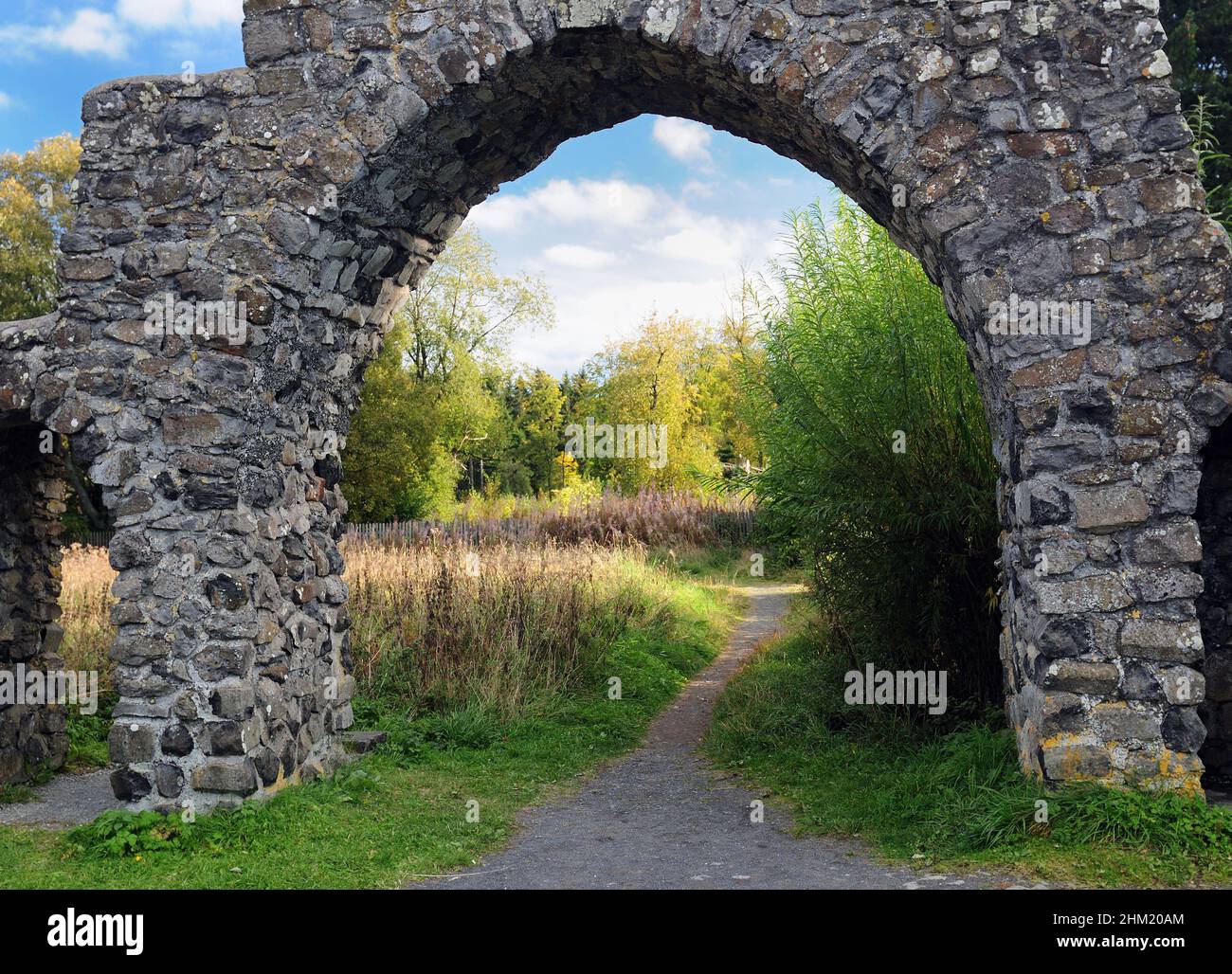 Stone Arch At The Entry Of The Black Moor In The Rhoen Mountains Germany On A Beautiful Sunny Autumn Day With A Clear Blue Sky And A Few Clouds Stock Photo