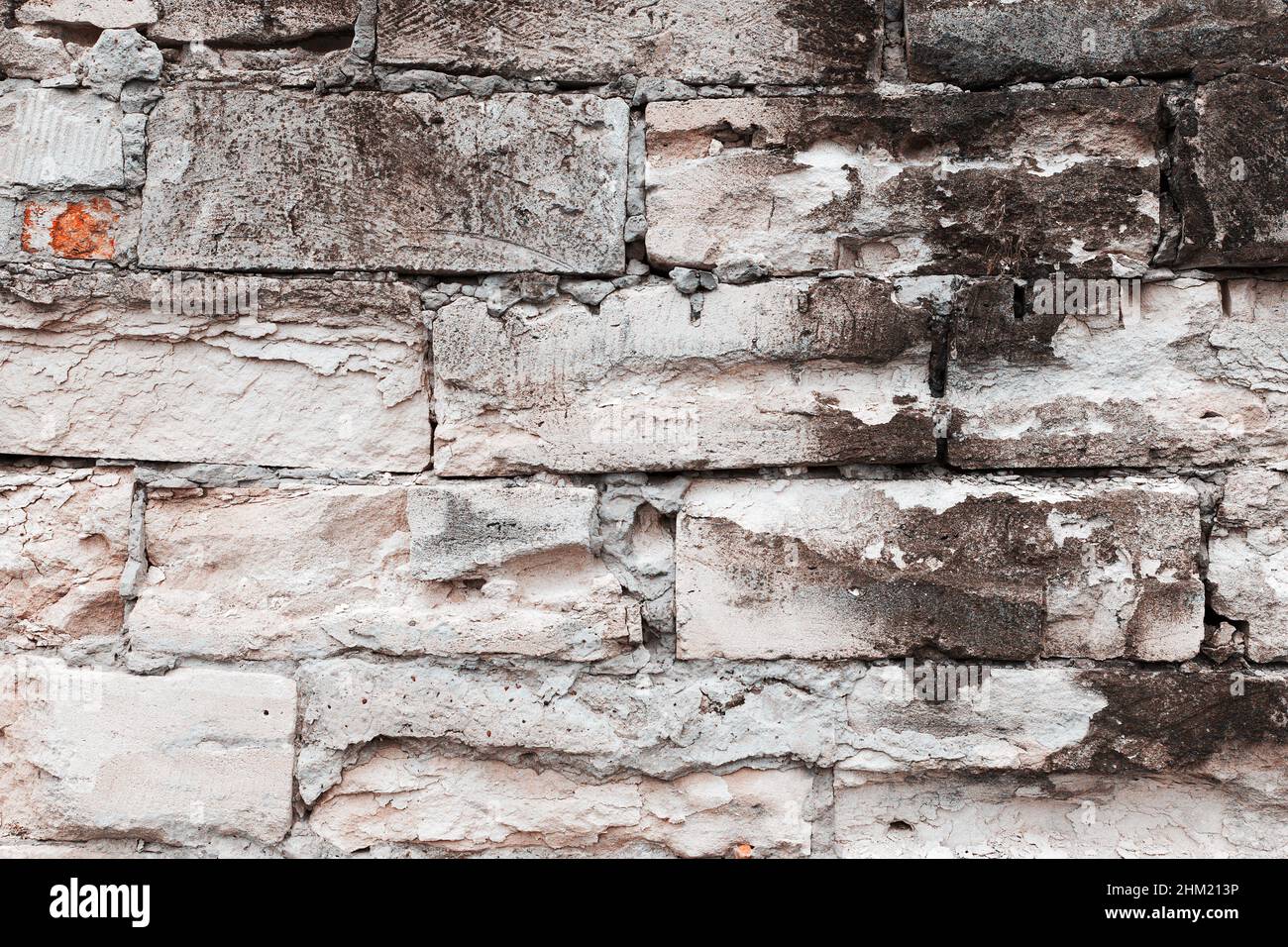 Abstract background old white brick wall with cracks and scratches ...