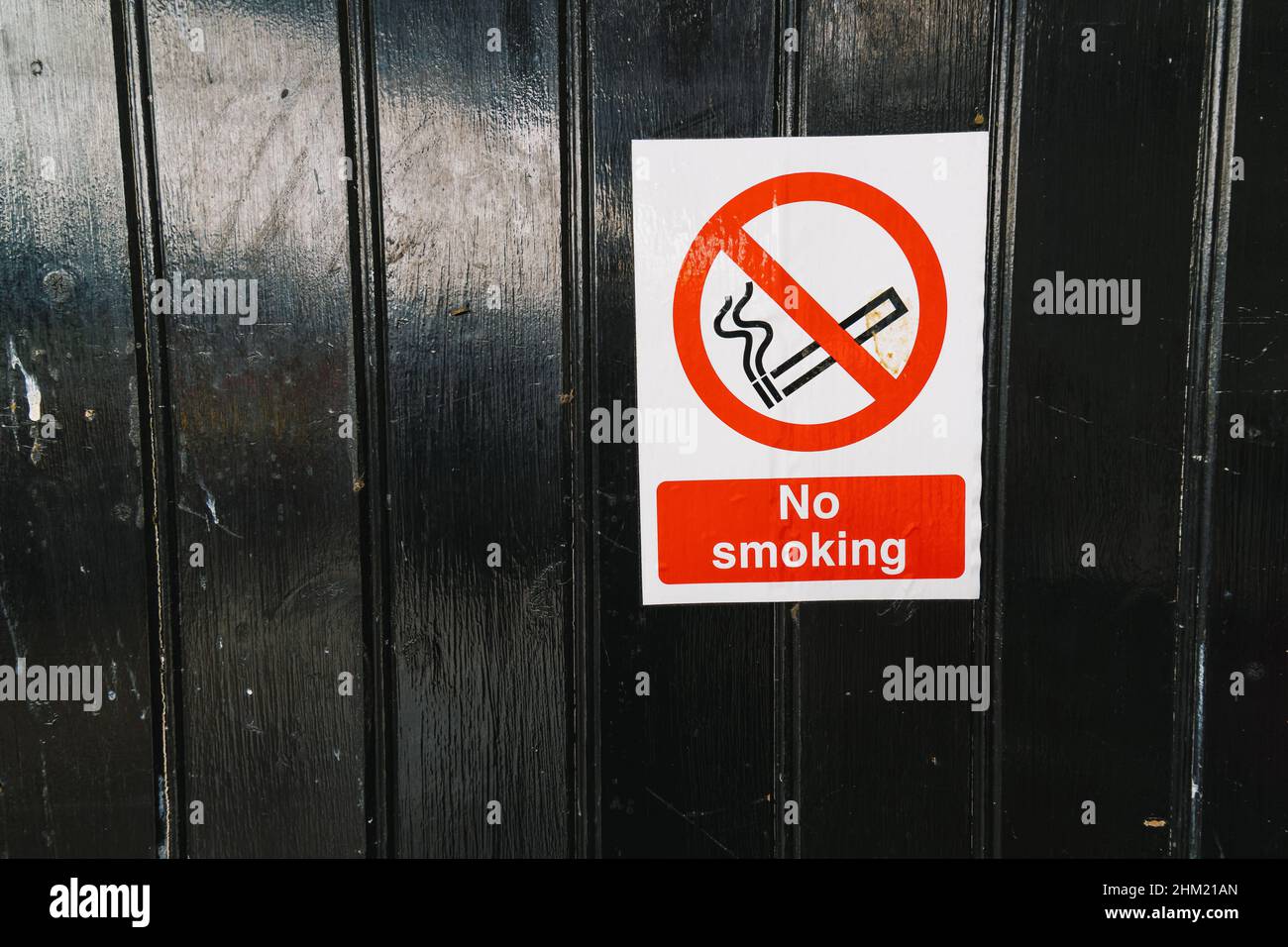 No smoking sign on a black wood en door, copy space for individual text ...