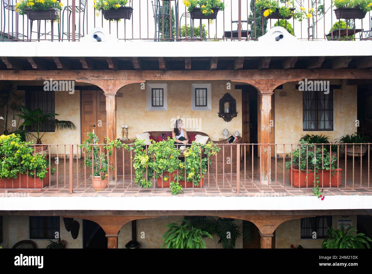 Woman on a hotel balcony in Antigua Guatemala Stock Photo