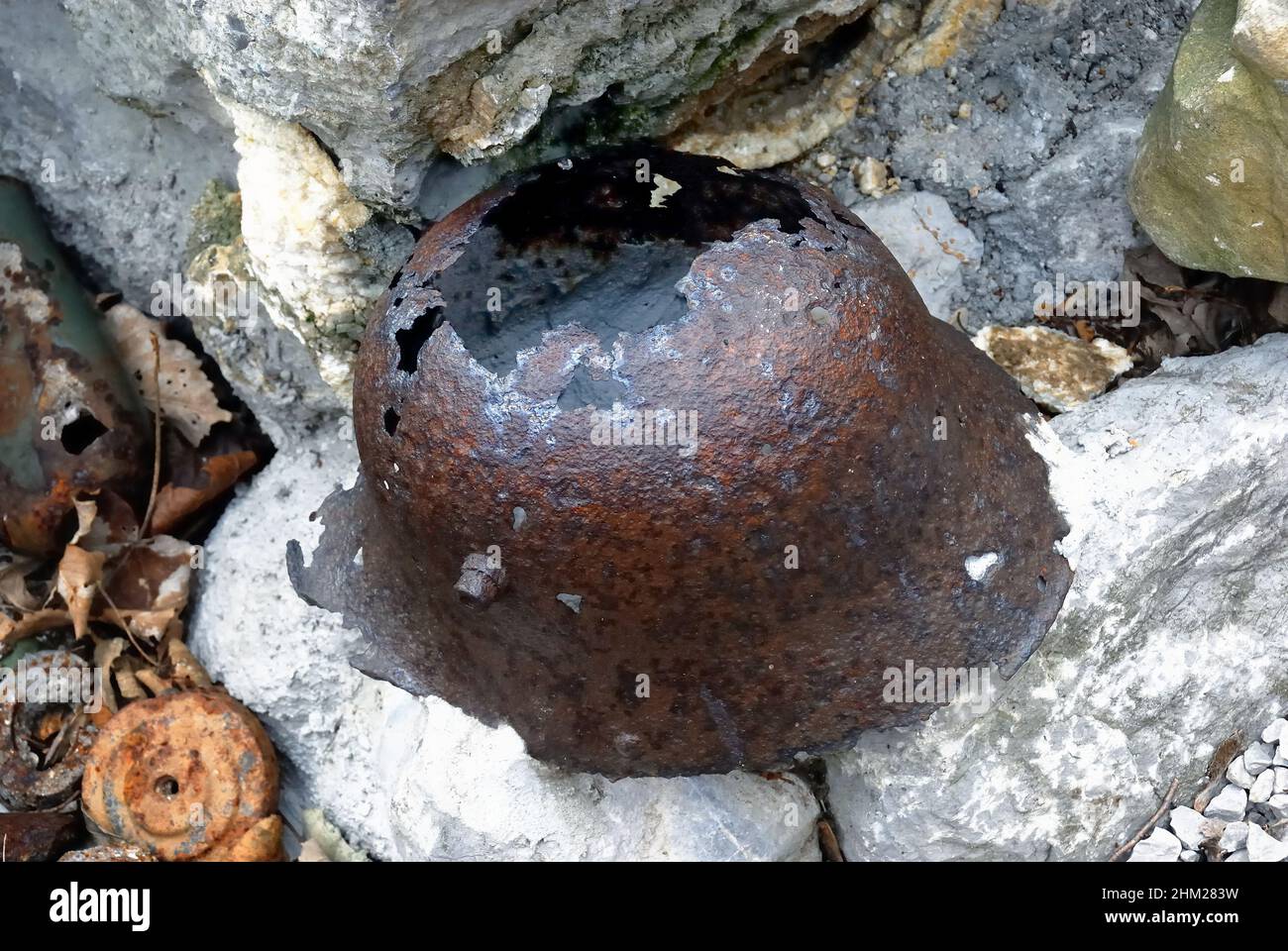 Mount Vodice (SLO) WWI : a German helmet. Its alloy of steel and nickel-chrome, more than one millimetre thick, was the most effective head protection in World War One. The helmet also contained a first-aid kit inside. Stock Photo
