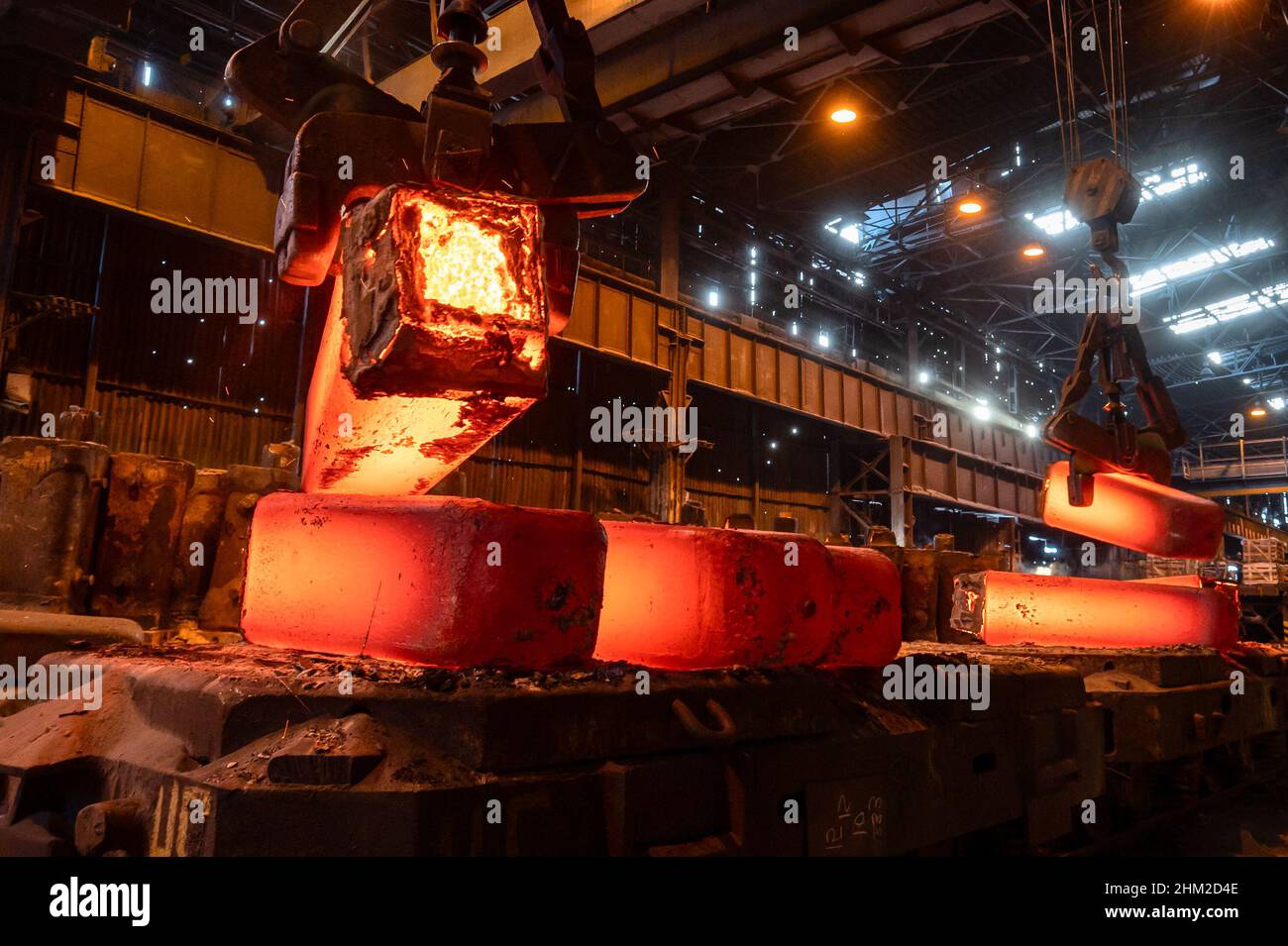 The red-hot metal casting is piled on the platform Stock Photo