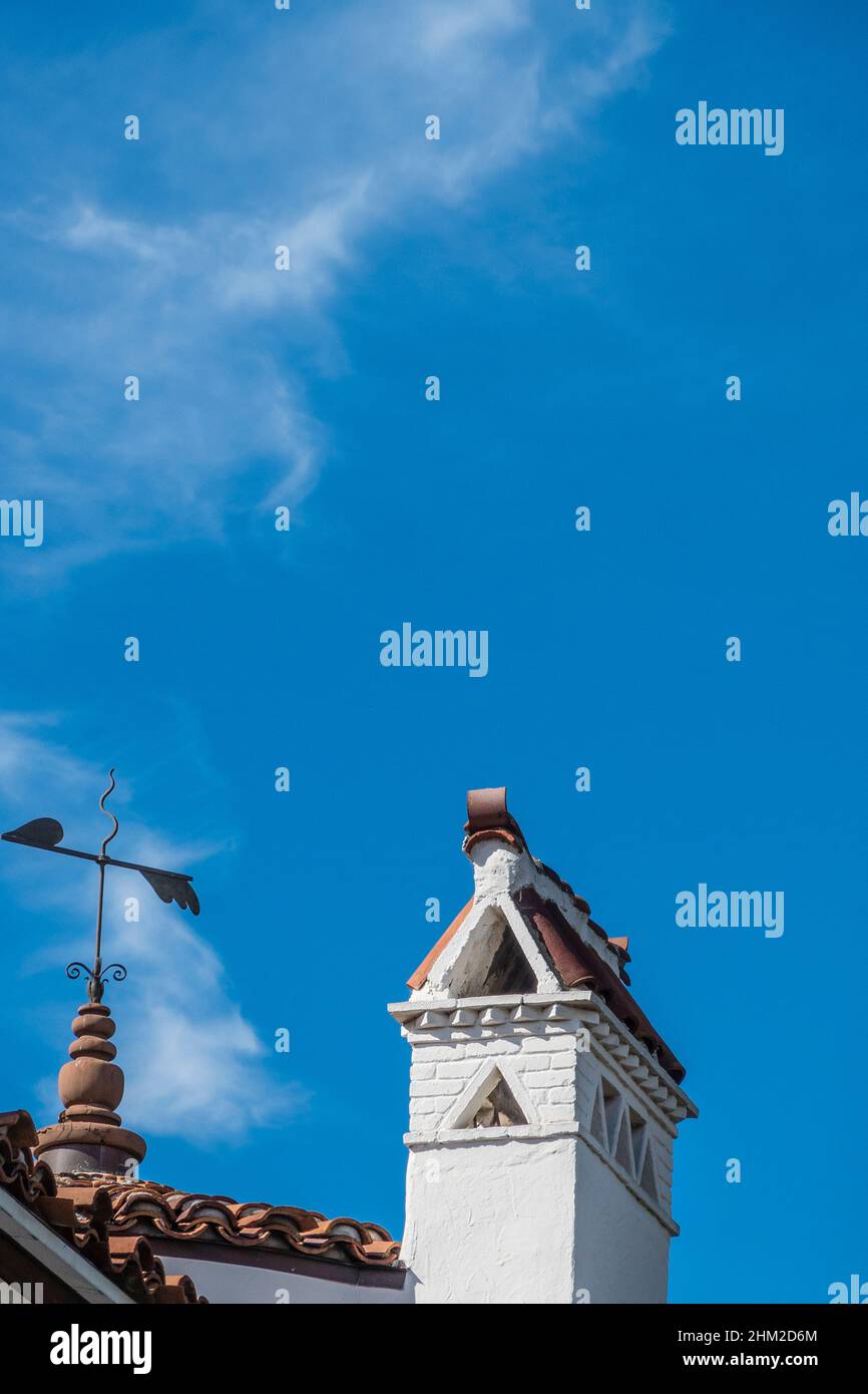 Weathervane and chimney in Spanish Colonial Revival style typical of