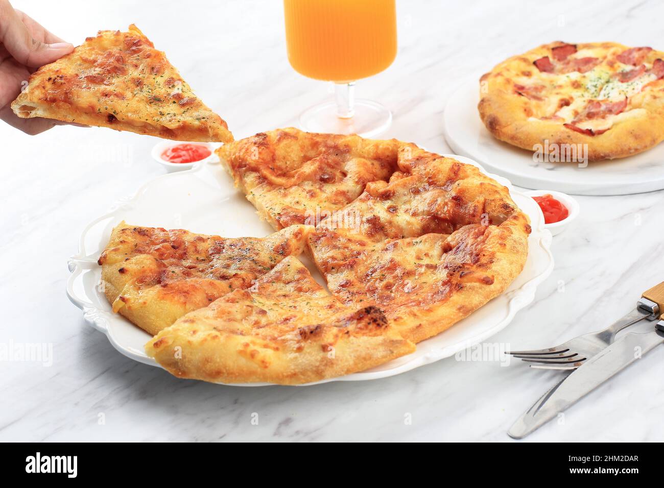 Pizza with Melted Cheese on Top, A Girl Take on Slice Pizza. Served on White Plate, Concept White Pizzeria. Selected Focus Stock Photo