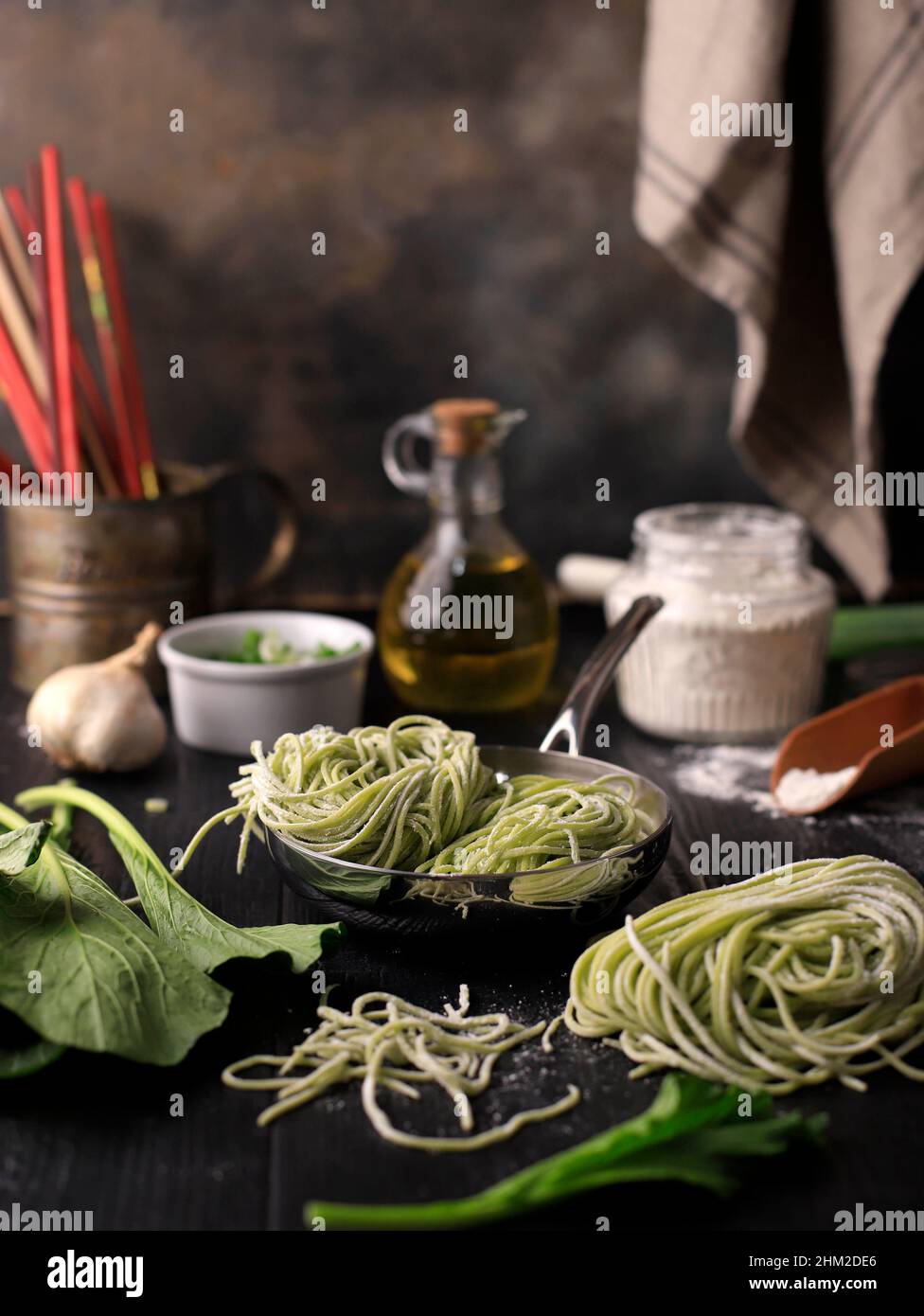 Homemade Raw Asian Green Vegetable Noodle in the Making. Home Cooking Process in the Kitchen (Mie Sawi Sayur). Stock Photo