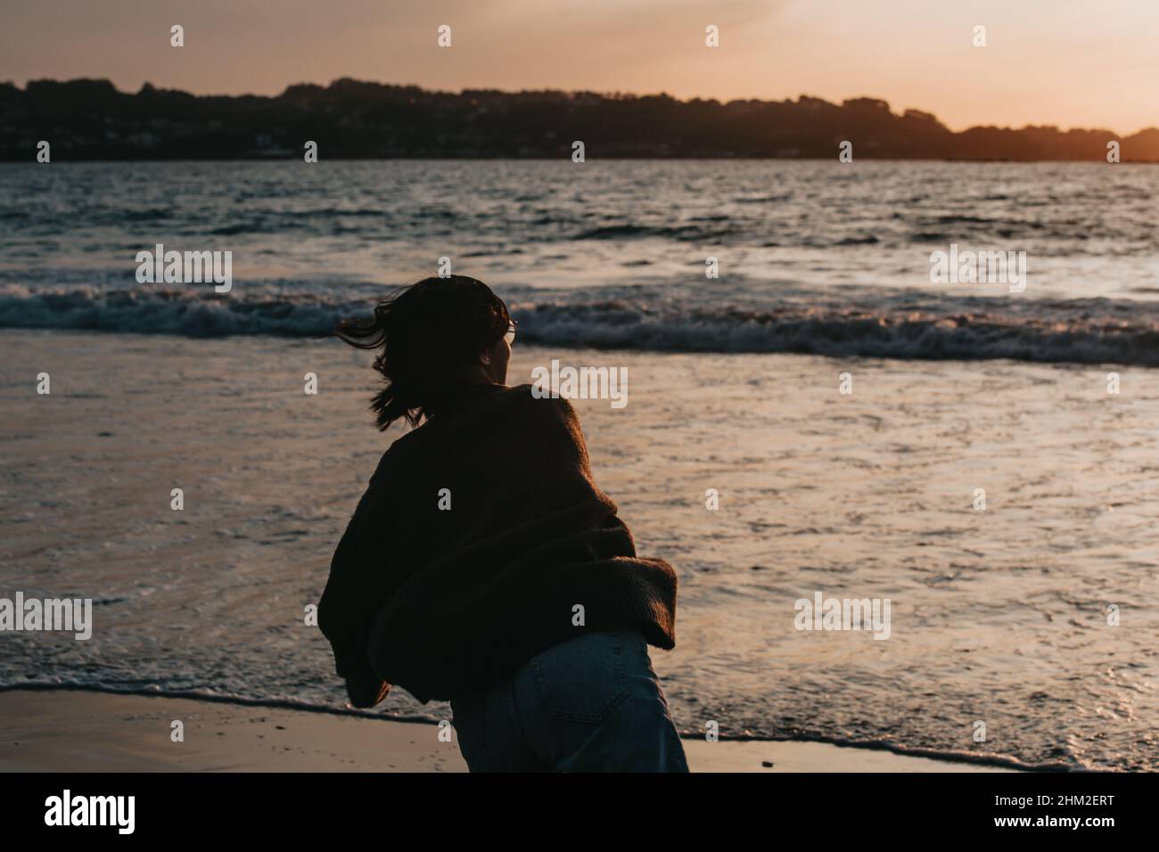 Woman watching sunset beach arms hi-res stock photography and images ...